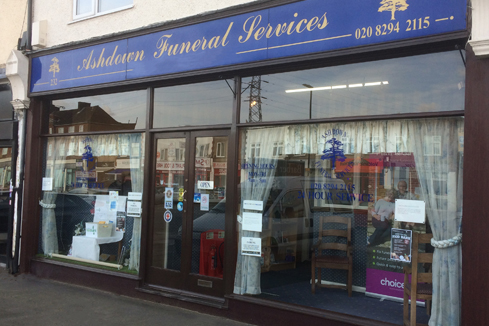 A store front with a blue sign reading Ashdown Funeral Services.