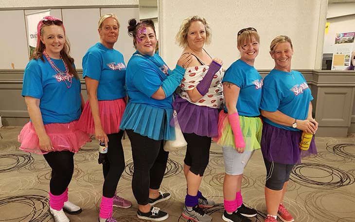 6 ladies dressed in bright coloured tutus and legwarmers ready for the 5 mile evening walk for the Rowcroft Hospice Charity.