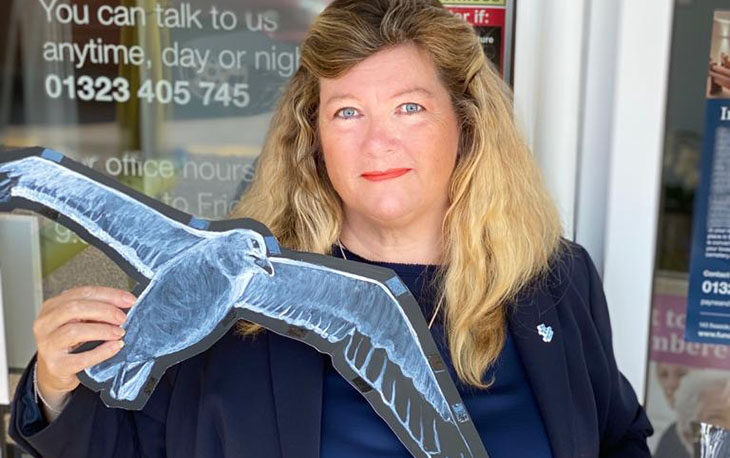 Picture of Danielle Steele holding hand painted seagull.