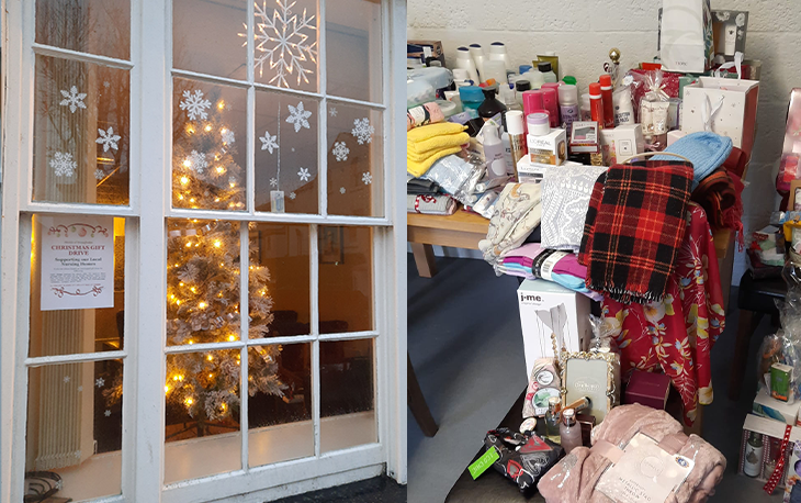 Festive window display with snowflakes and table with various donations.