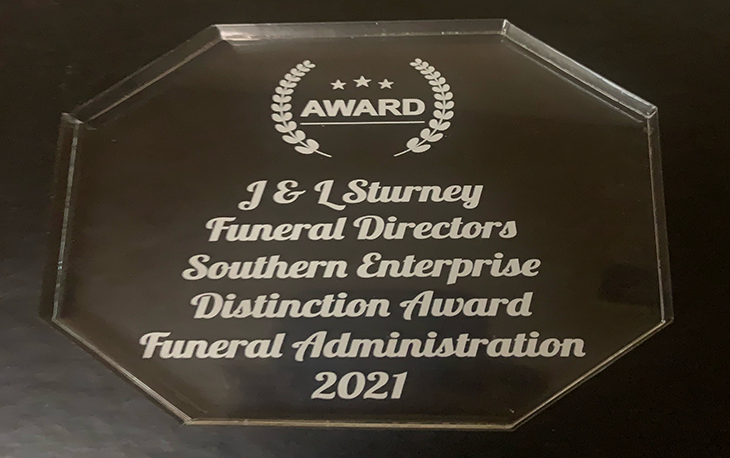 A glass plaque awarded to J & L Sturney Funeral Directors.