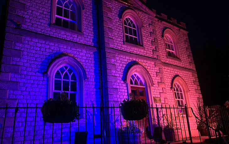 A building with illuminating pink and blue lights