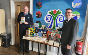 Book donations being collected by two men.